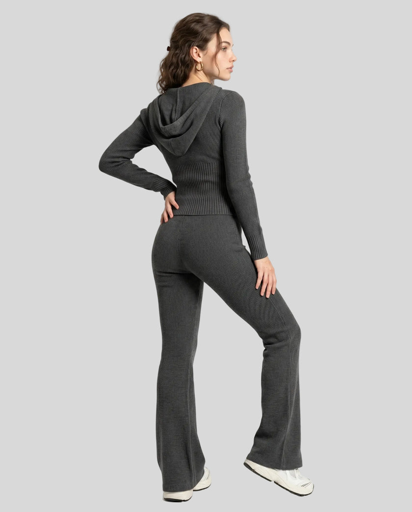 Model back full body wearing dark gray Athlesi FormFlare zip hoodie and flare pant set