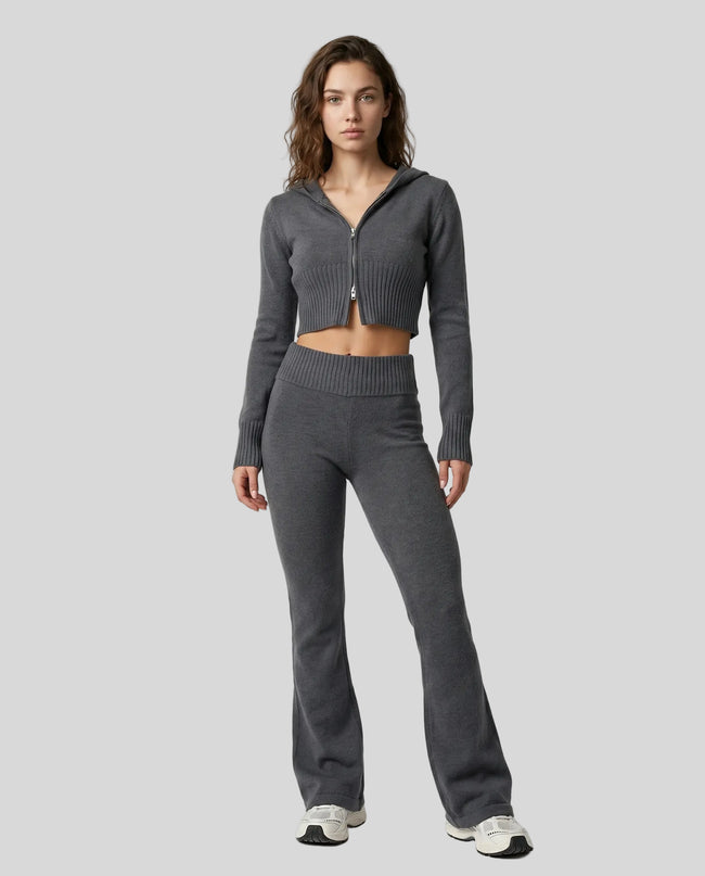 Model front full body wearing dark gray Athlesi FormFlare zip hoodie and flare pant set