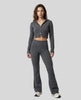 Model front full body wearing dark gray Athlesi FormFlare zip hoodie and flare pant set