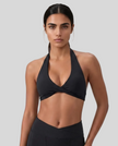 FormLine halter sports bra in black styled on model upper body front view