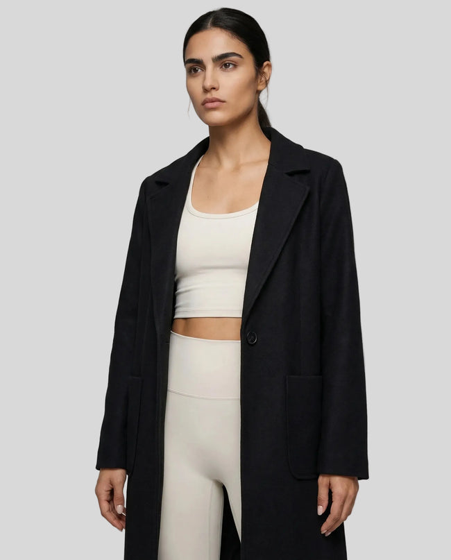 FormLine Trench in black worn by model mid body front view highlighting fit and structure