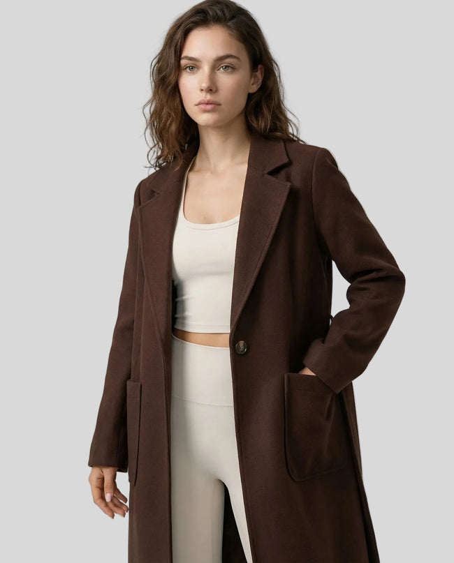 FormLine Trench in dark brown worn by model mid body front view highlighting fit and structure