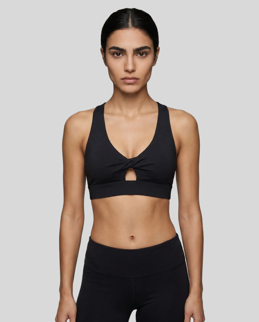 Model wearing the FormLine Twist Sports Bra in black front view