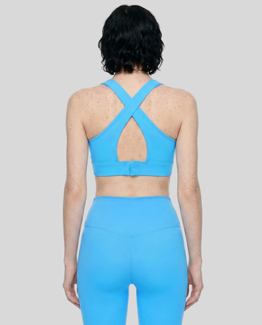 Back view of the FormLine Twist Sports Bra in blue, highlighting the cross-back design