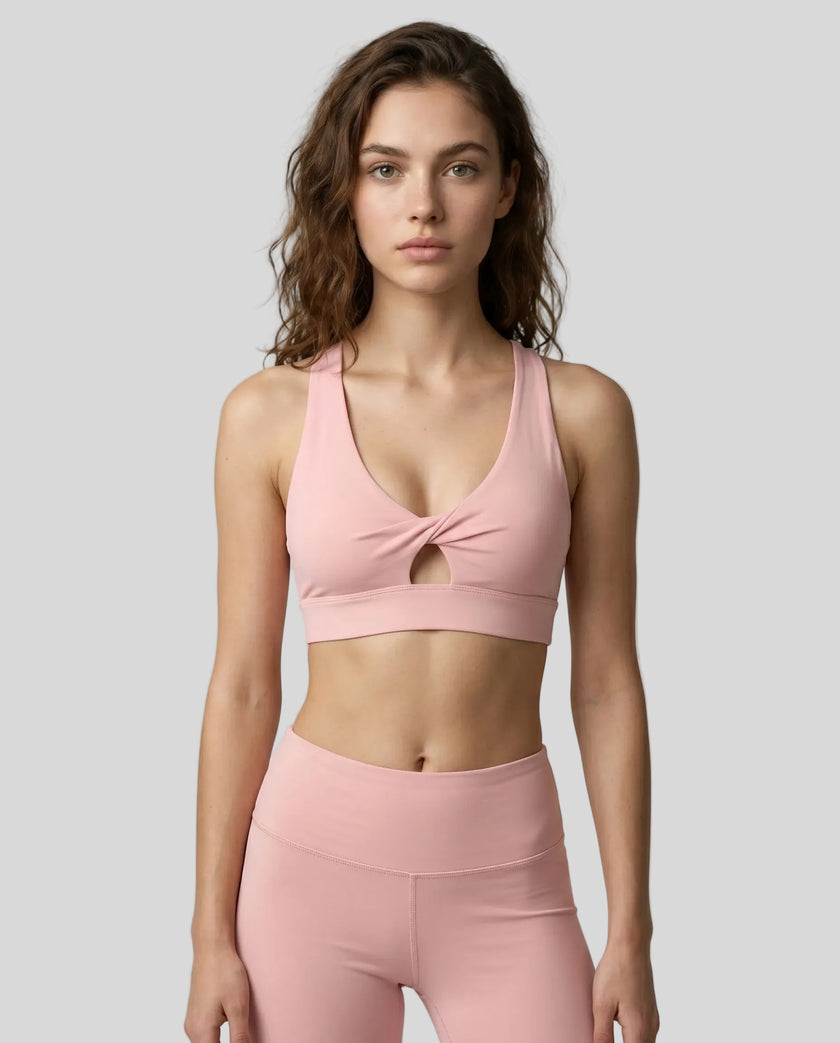Model wearing the FormLine Twist Sports Bra in pink front view