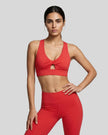 Model wearing the FormLine Twist Sports Bra in red front view