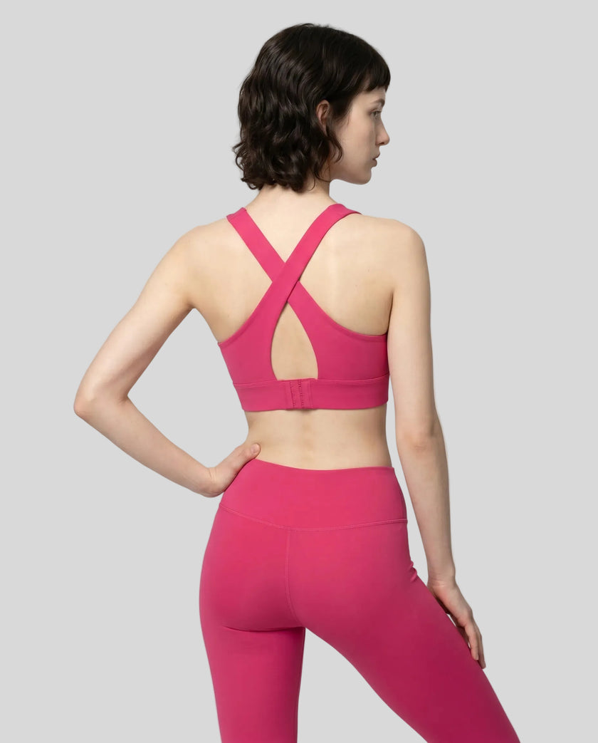 Back view of the FormLine Twist Sports Bra in rose red, highlighting the cross-back design