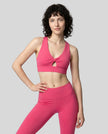 Model wearing the FormLine Twist Sports Bra in rose red front view