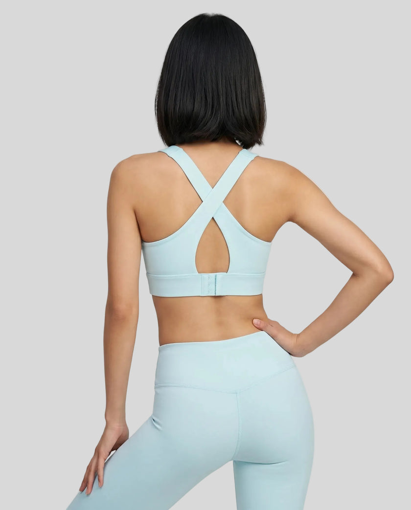 Back view of the FormLine Twist Sports Bra in sky blue, highlighting the cross-back design