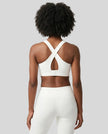 Back view of the FormLine Twist Sports Bra in white, highlighting the cross-back design