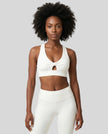 Model wearing the FormLine Twist Sports Bra in white front view