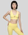 Model wearing the FormLine Twist Sports Bra in yellow front view