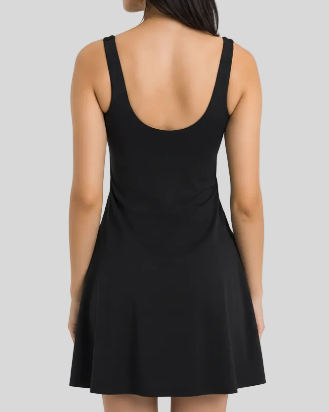 Black activewear dress worn by a woman on a light gray background