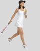 Side view of FormMove Active Dress in white highlighting built-in shorts with pockets