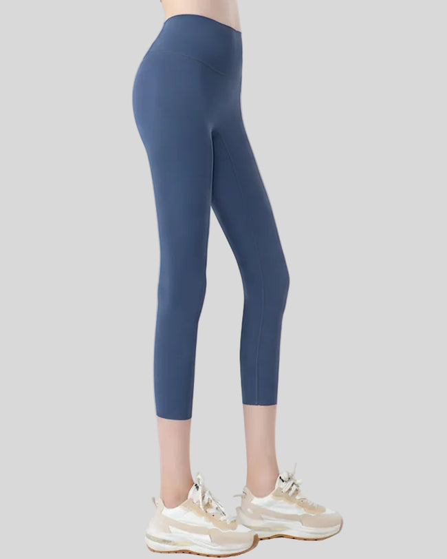 Right side view of dusty blue Athlesi GlowForm Sculpt Cropped Legging