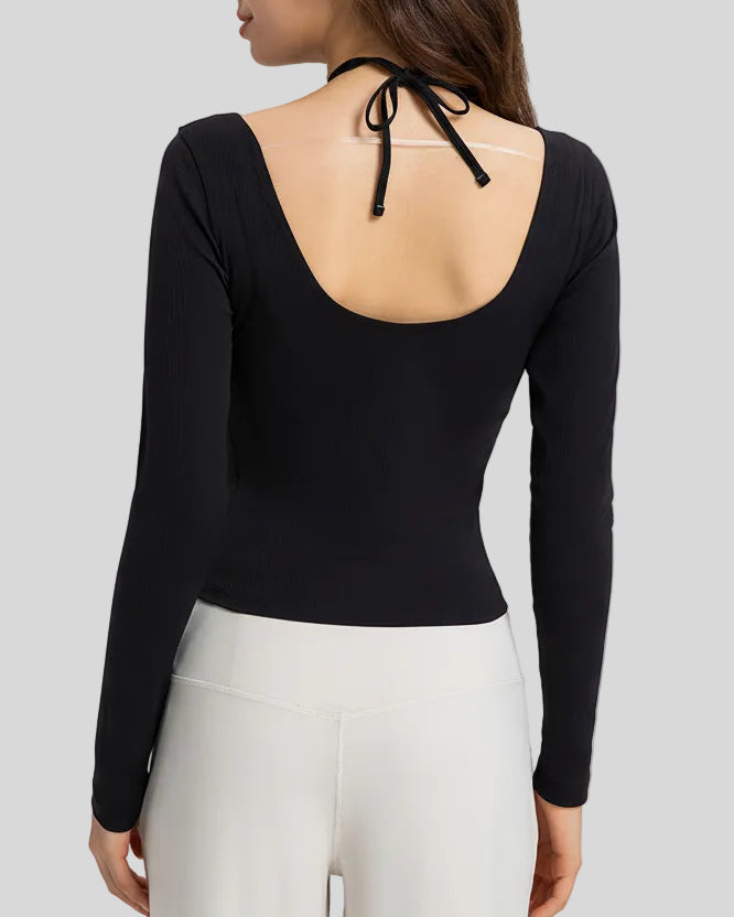Back view showing open-back halter design with adjustable tie on Athlesi HaloContour top in black