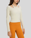 Angled front view highlighting halter neckline and ribbed texture of Athlesi HaloContour top in ivory