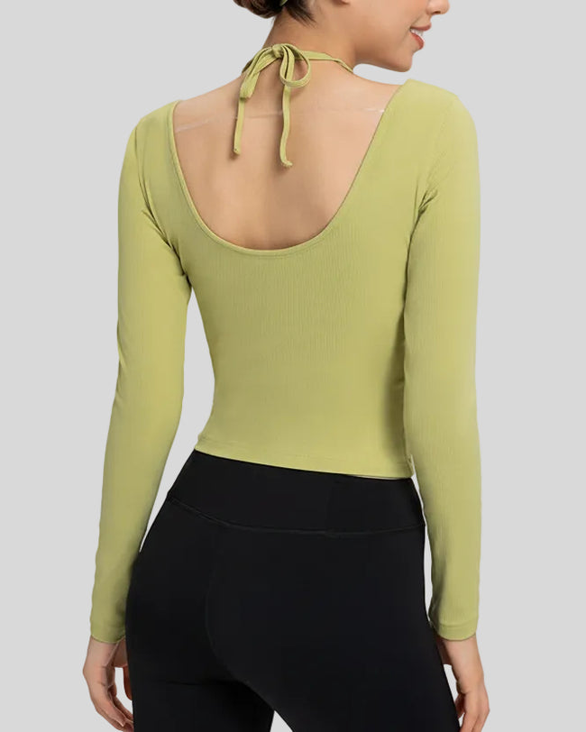 Back view showing open-back halter design with adjustable tie on Athlesi HaloContour top in yellow green
