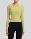 Front view of Athlesi HaloContour halter long sleeve top with ribbed fabric and fitted silhouette in yellow green