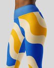 Mid body side view of cerulean swirl leggings 