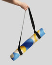 Model carrying rolled yoga mat by hand