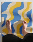 Model feet standing on cerulean swirl yoga mat