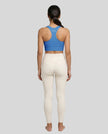 Athlesi model wearing cerulean blue sports bra back view
