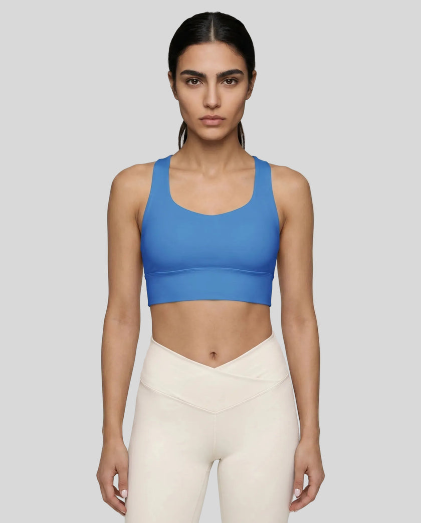 Athlesi model wearing cerulean blue sports bra front view
