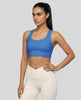 Athlesi model wearing cerulean blue sports bra left angle 