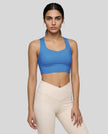 Athlesi model wearing cerulean blue sports bra right angle 