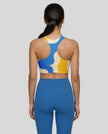 Athlesi model wearing cerulean swirl sports bra back view