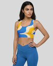 Athlesi model wearing cerulean swirl sports bra left angle