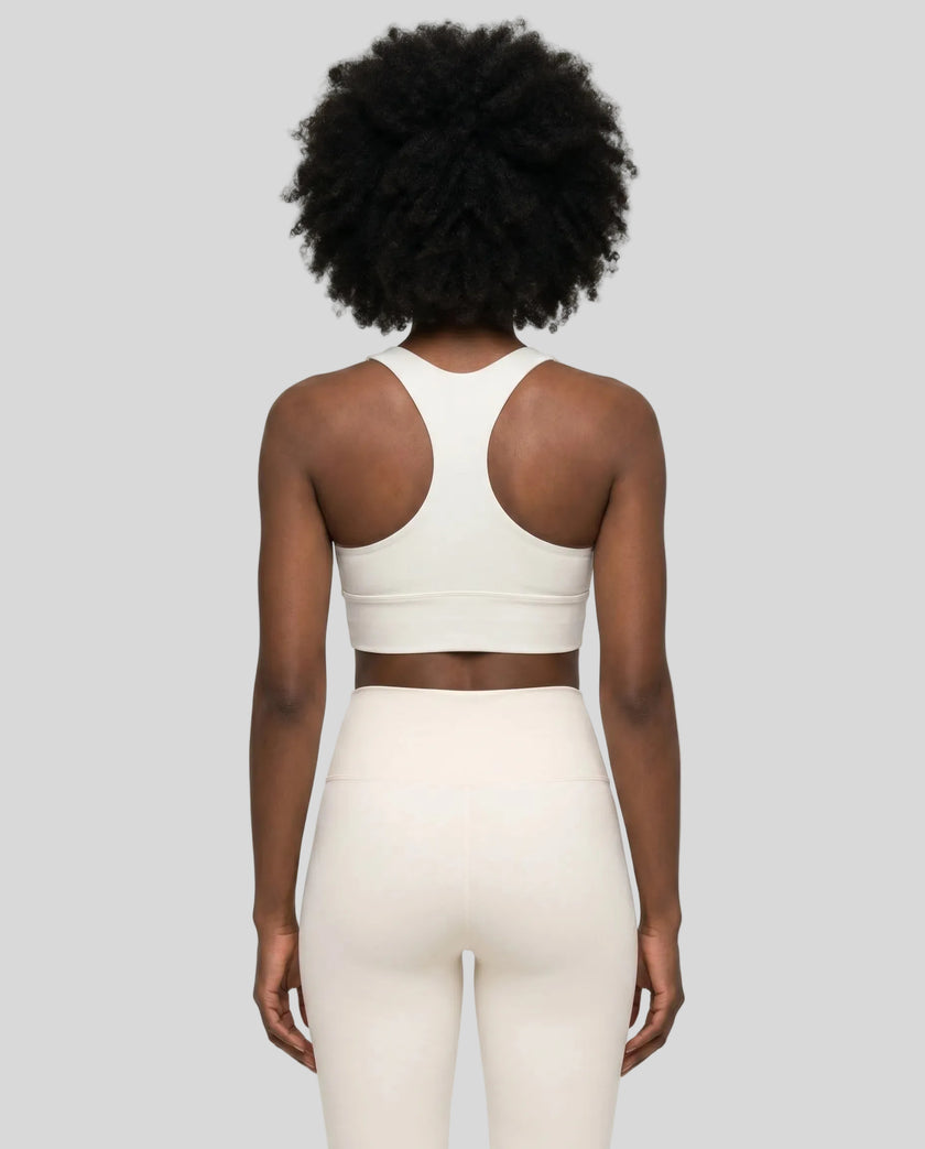 Athlesi model wearing cloud dancer sports bra back view