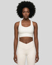 Athlesi model wearing cloud dancer sports bra front view