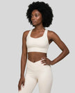 Athlesi model wearing cloud dancer sports bra left angle