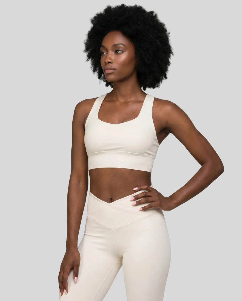 Athlesi model wearing cloud dancer sports bra left angle