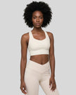 Athlesi model wearing cloud dancer sports bra right angle