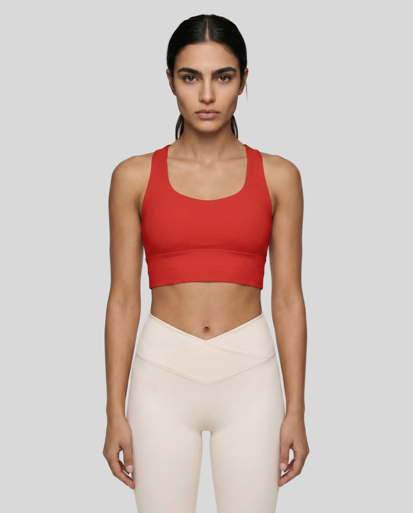 Athlesi model wearing tomato red sports bra front view