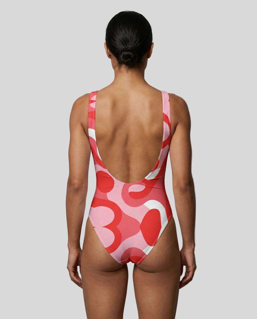 Model wearing red swirl swimsuit back view 
