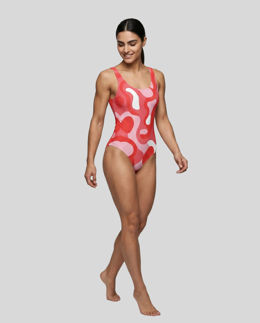 Model wearing red swirl swimsuit front left angle