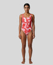 Model wearing red swirl one piece swimsuit front