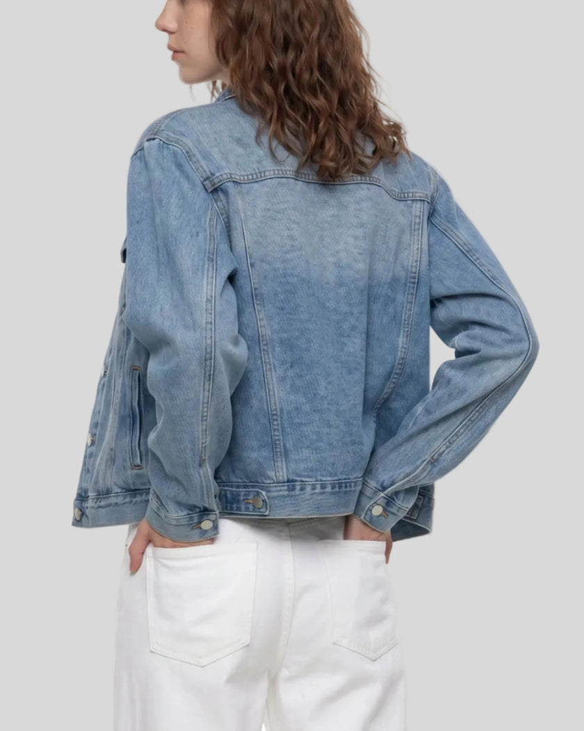Rear angled view of a model wearing the Heritage Denim Jacket in Blue