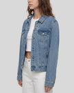 Side view of a model wearing the Heritage Denim Jacket in Blue