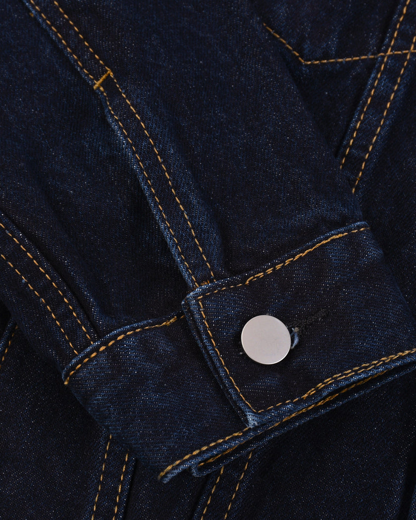 Close-up of the adjustable button cuff on the Heritage Denim Jacket in Navy Blue