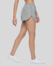 Side view of a model wearing the Heritage Lounge Shorts in Flower Gray