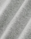 Close-up of Athlesi Heritage Quarter-Zip Sweatshirt in flower gray heathered fabric texture with soft diagonal folds.