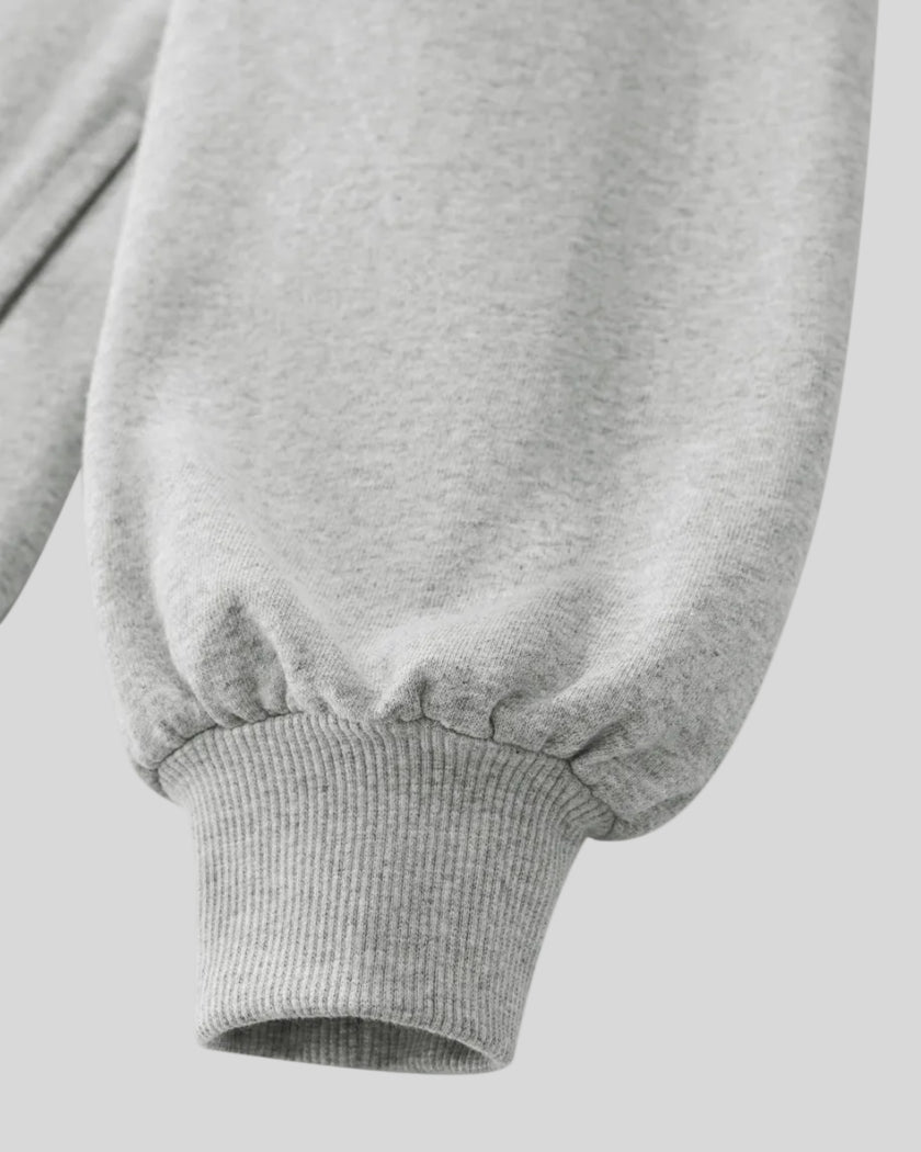 Close-up of flower gray Athlesi Heritage Quarter-Zip Sweatshirt with banded cuffs on a white background