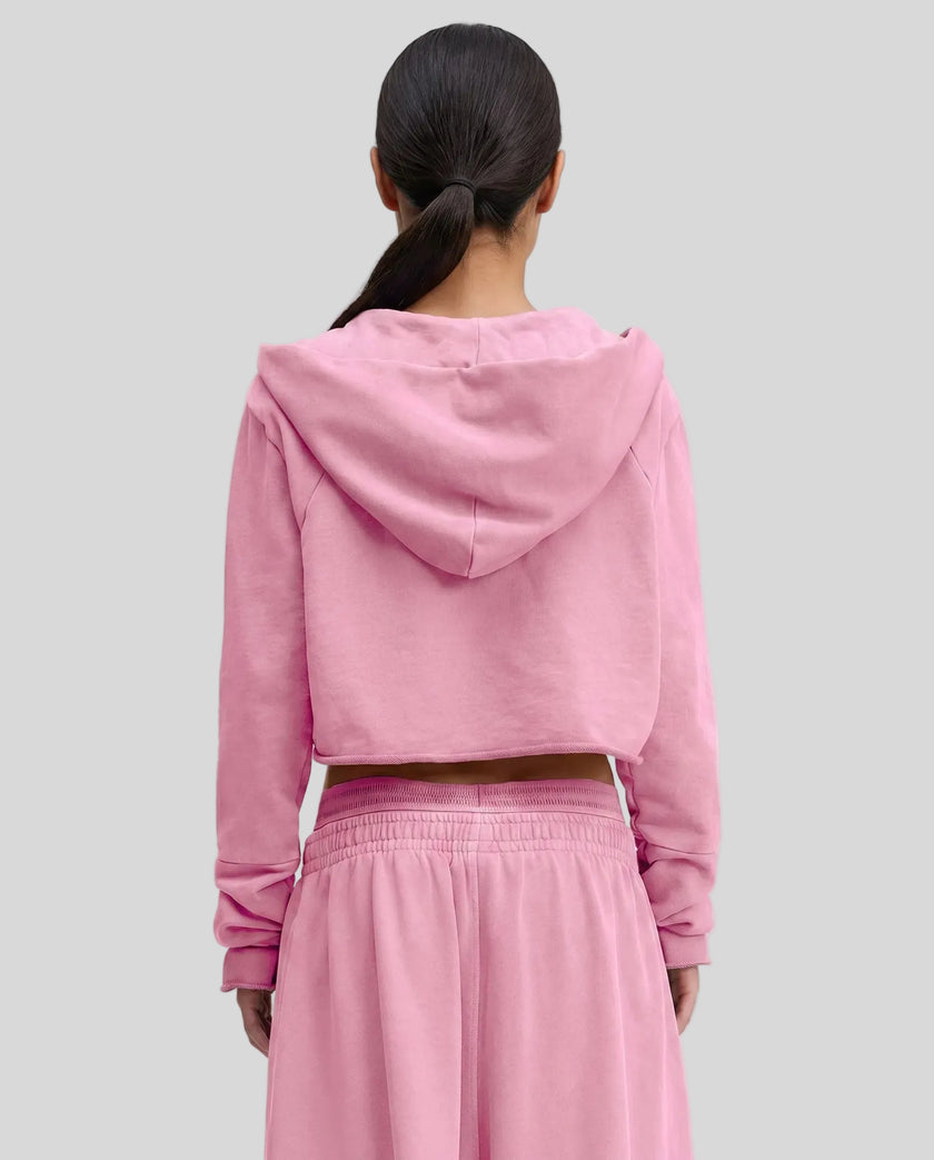 Back view of a model wearing the Heritage Washed Hoodie in Rose Pink