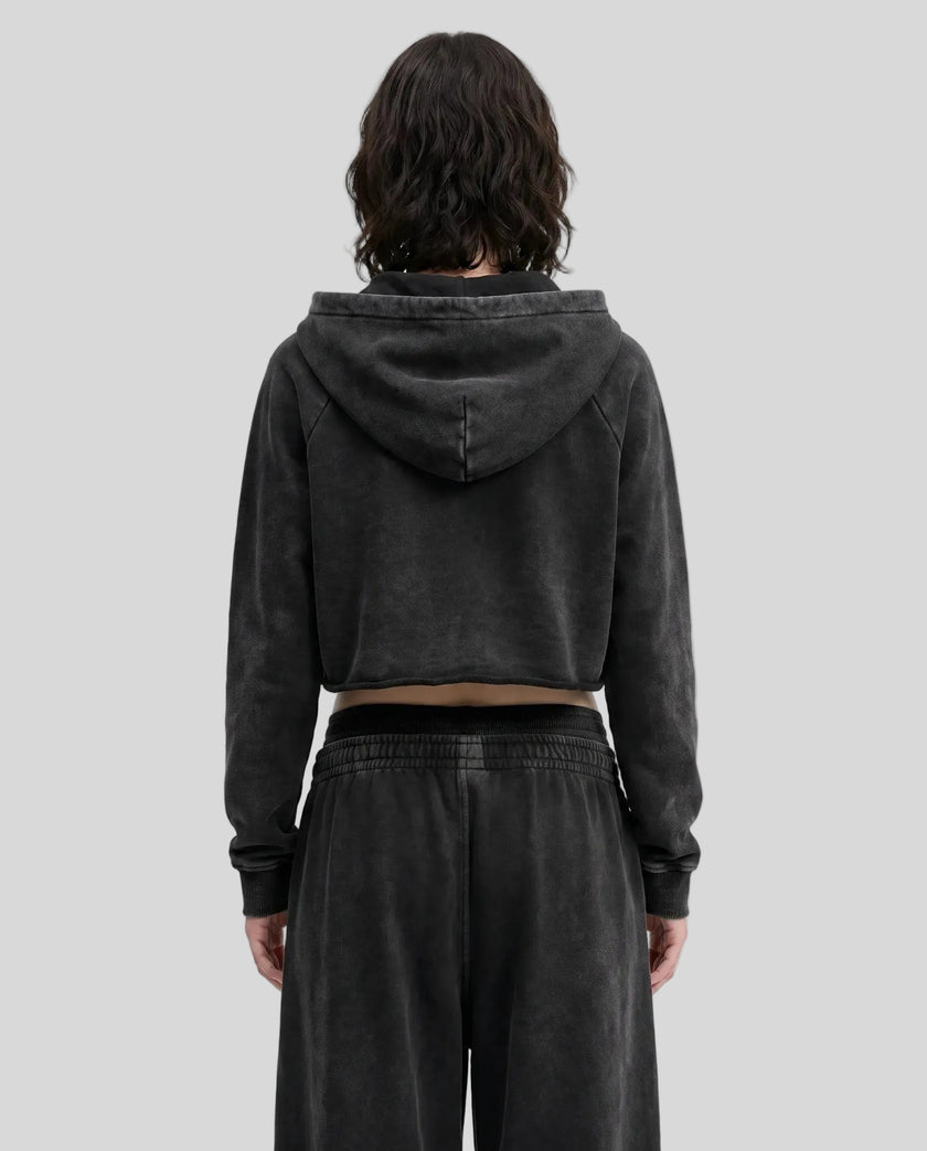 Back view of a model wearing the Heritage Washed Hoodie in Washed Black