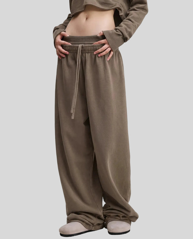 Front angled view of a model wearing the Heritage Washed Pants in Coffee